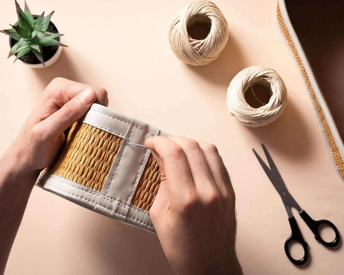 Hands weaving a beige and brown Darido large organizer box with scissors and twine nearby. - Large Organizer Box | 30x22 cm