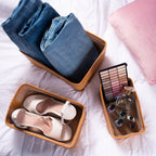Set of three darido natural fiber storage boxes with brown leather trim holding jeans, shoes, and cosmetics. - Set of 3 Handmade Natural Fiber Storage Boxes with Colored Leather Trim