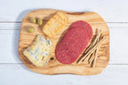 Darido handmade olive wood cutting board with cheese, salami, breadsticks, and olives on white surface. - Handmade Olive Wood Cutting Board – Reversible, Rustic & Food-Safe | 12x7" (30x18cm)
