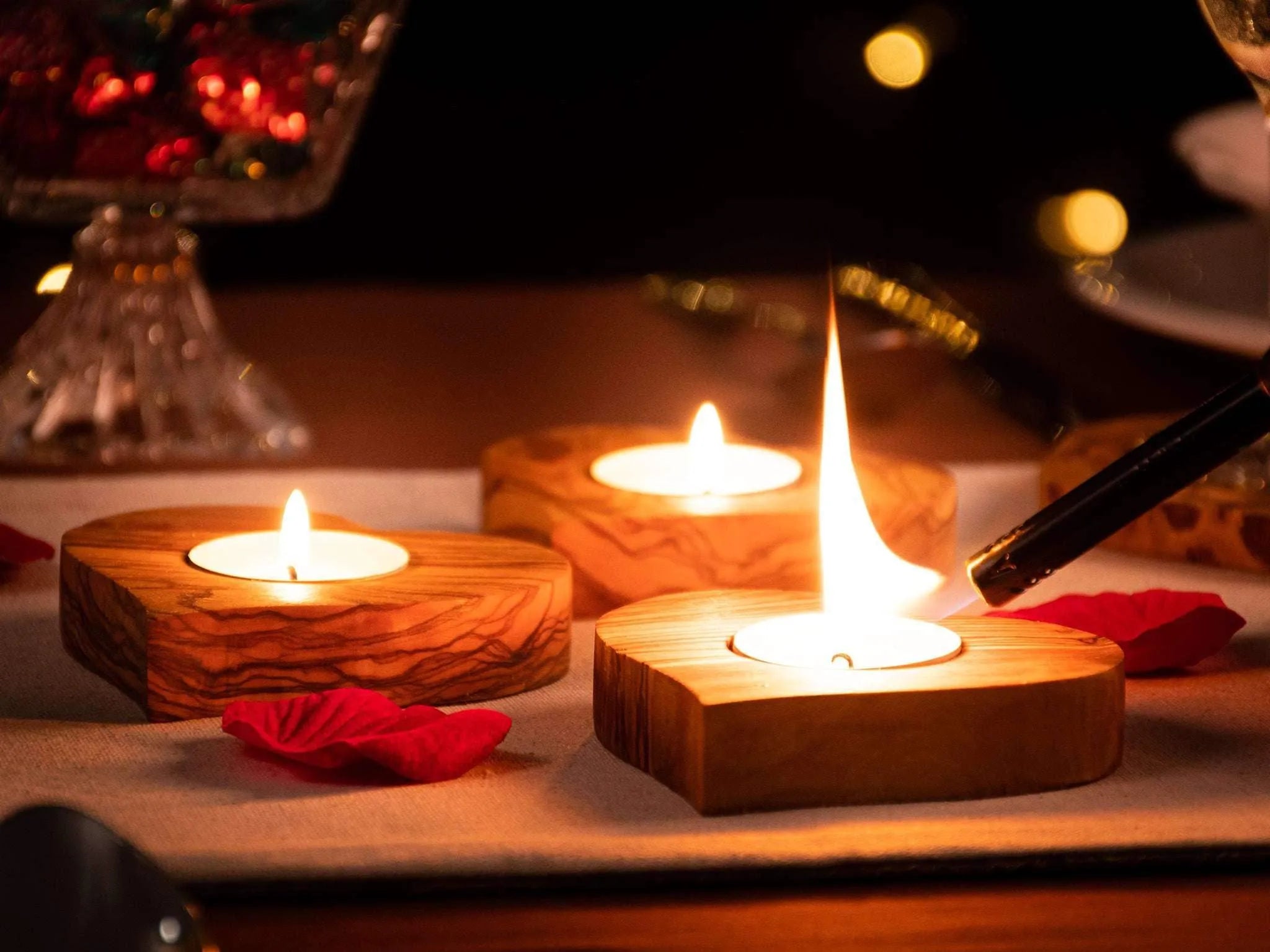 Darido olive wood heart-shaped tealight holder with warm candlelight glow on table. - Olive Wood Tealight Holder - Heart Shape - 10x10x2 cm