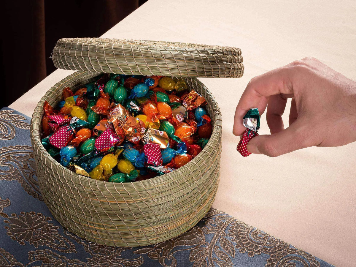 Round halfa darido basket with lid, filled with colorful wrapped candies on blue patterned surface. - Round Halfa Basket