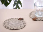 Set of 2 round beige Darido cotton coasters with braided design and brown leather tabs. - Set of 2 Beige Coasters - 15cm