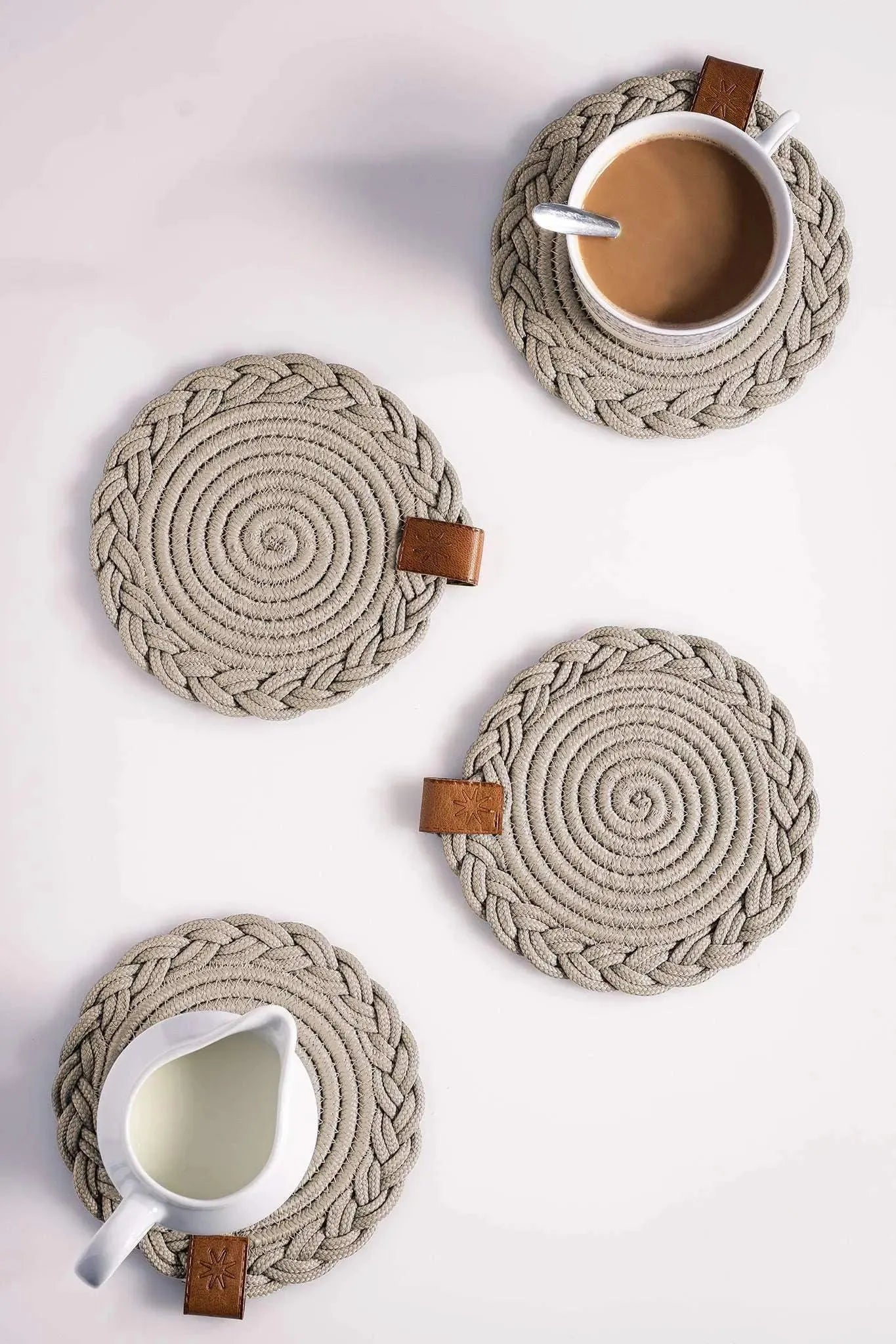 Set of 2 round beige darido cotton coasters with braided spiral design and brown leather tags. - Set of 2 Beige Coasters - 15cm