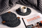 Set of 2 black Darido cotton coasters with textured spiral design on a tabletop. - Set of 2 Black Coasters- 15cm