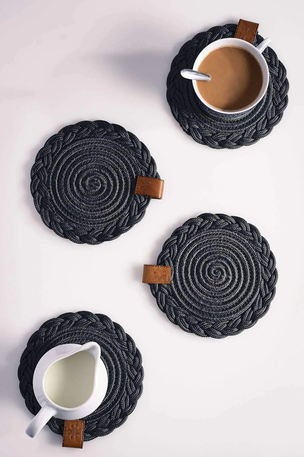 Set of 2 Darido black cotton coasters with braided spiral design and leather tag, 15cm. - Set of 2 Black Coasters- 15cm