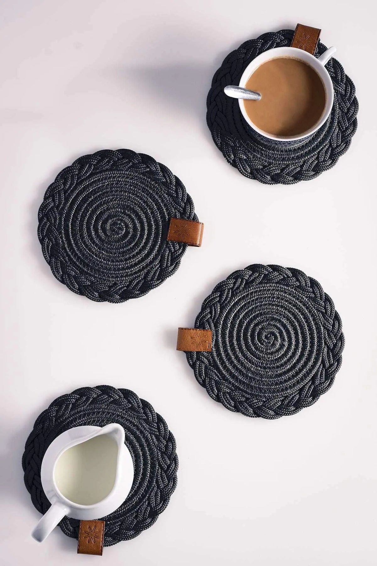 Set of 2 Darido black cotton coasters with braided spiral design and leather tag, 15cm. - Set of 2 Black Coasters- 15cm