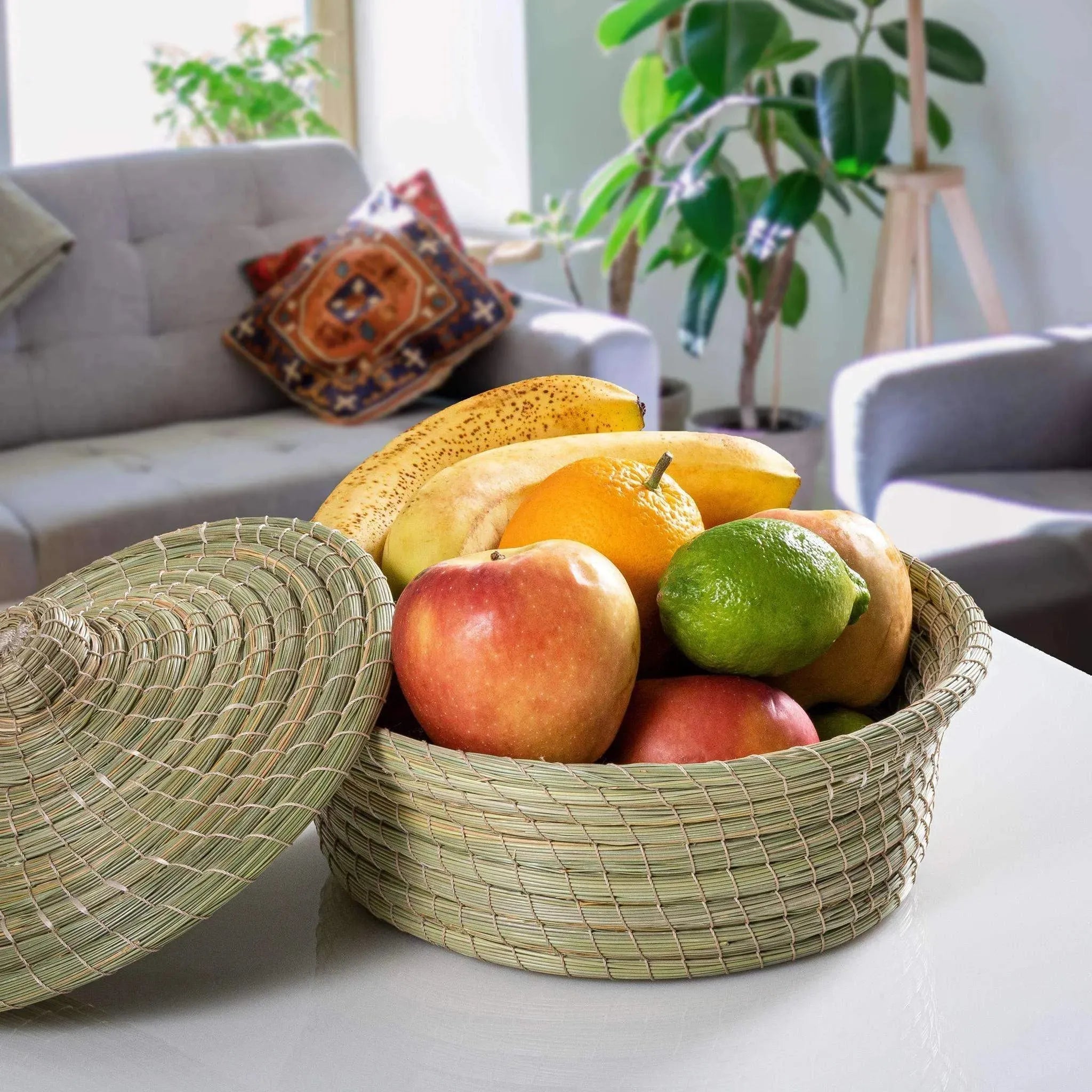 Round woven halfa basket with lid holding mixed fruit, handcrafted darido style. - Traditional Halfa Basket
