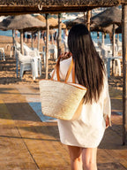 Natural woven darido shopping bag with tan leather handles carried on shoulder. - Shopping Bag Saaf with Leather L
